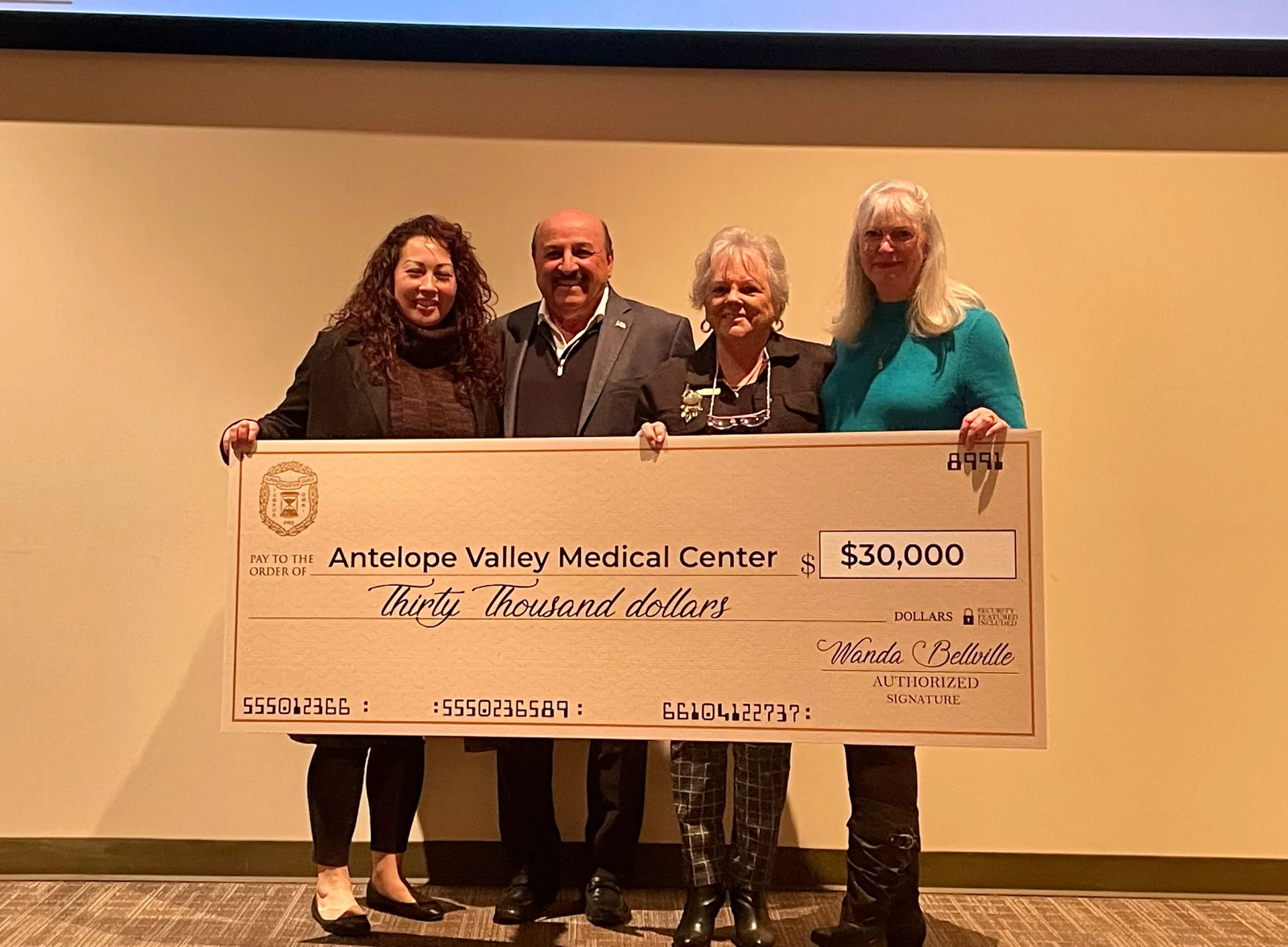 people holding a large check