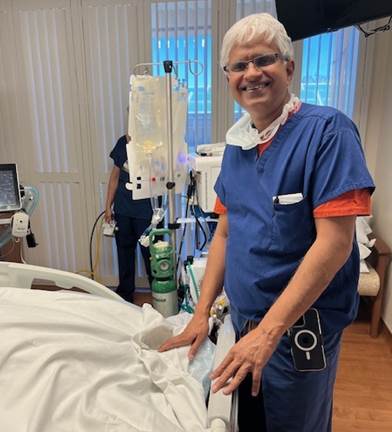 With pride, Dr. Pramod Kadambi, M.D., stands at Michael Francis’ bedside during Antelope Valley Medical Center’s first ECMO procedure.