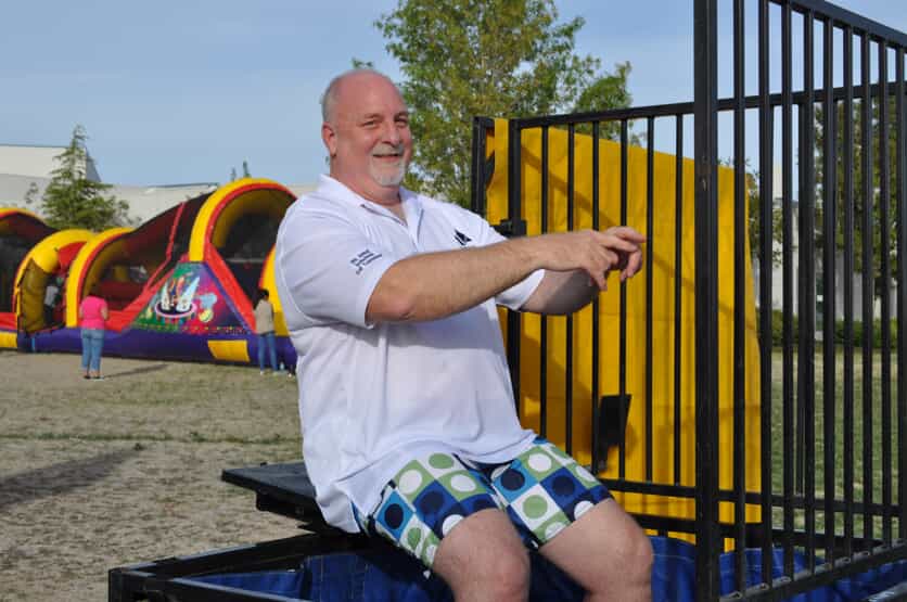 don sitting on dunk tank at 60th anniversary event