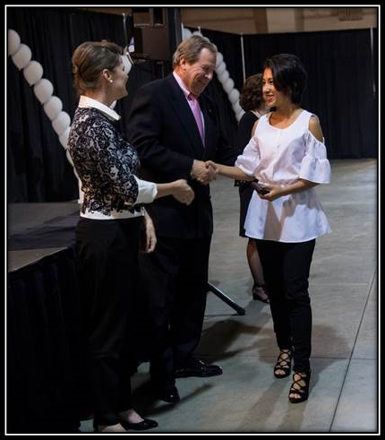 Chief Operating Officer and Chief Financial Officer Colette Menzel and Chief Executive Officer Michael Wall congratulate a volunteer