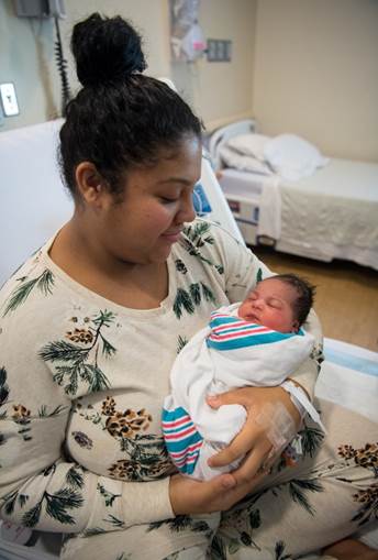 Chanel Canada holding her new baby girl 