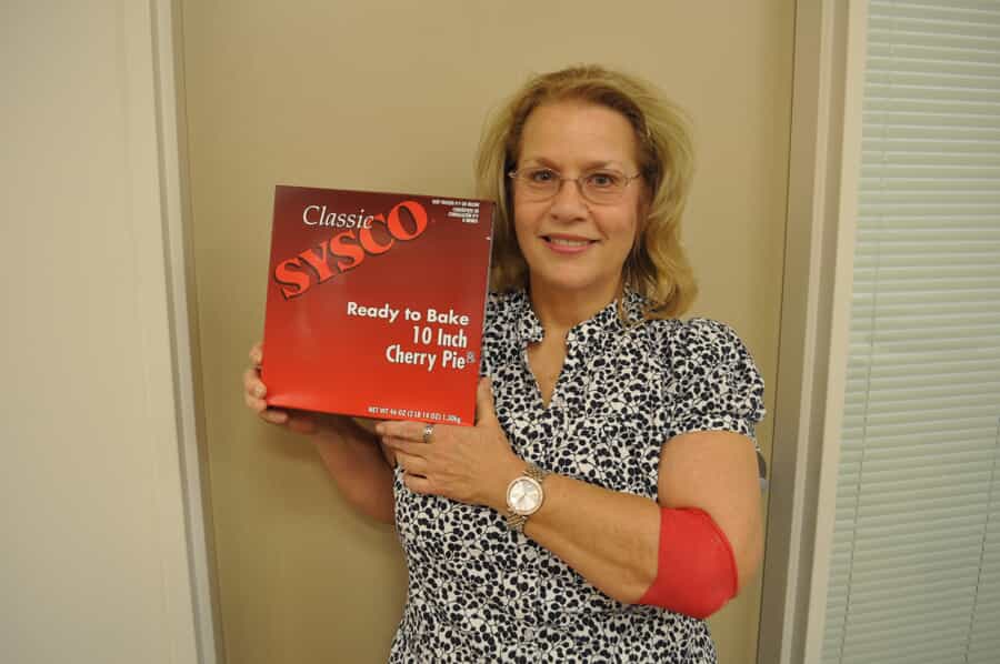 woman holding up her free pie