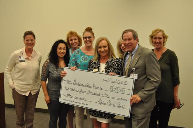 Members of the Alpha Charter Guild holding check