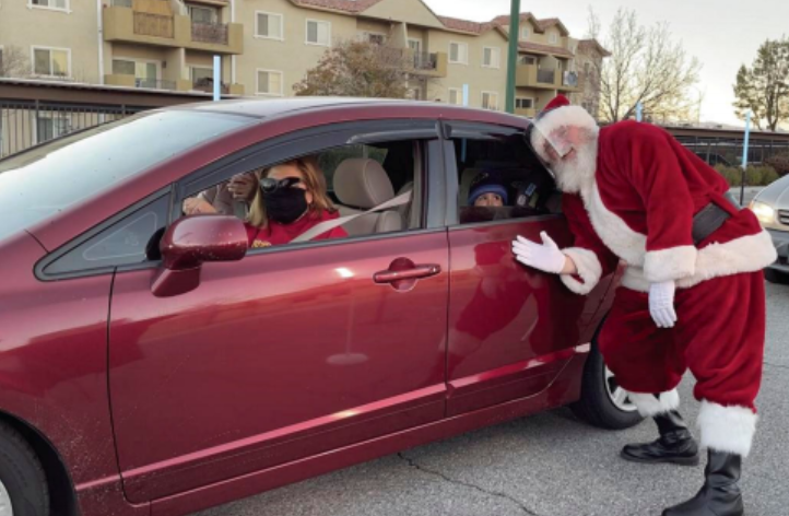 Santa posed alongside vehicle for a safely distanced photo during Frosty Fest