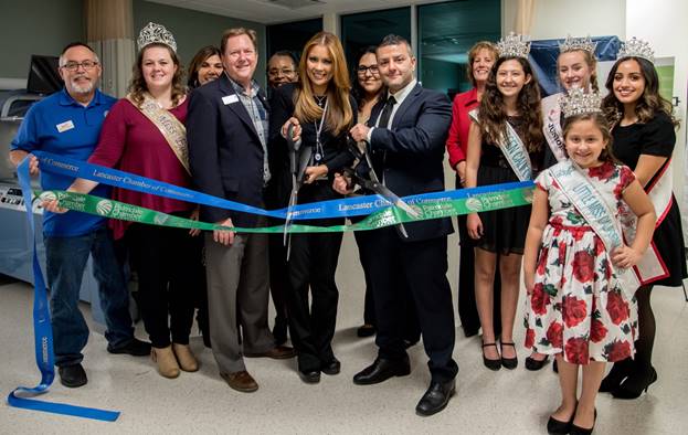 group of people cutting ribbon